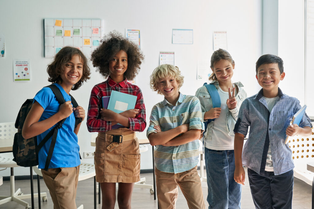 portrait happy cheerful smiling diverse schoolchildren classroom